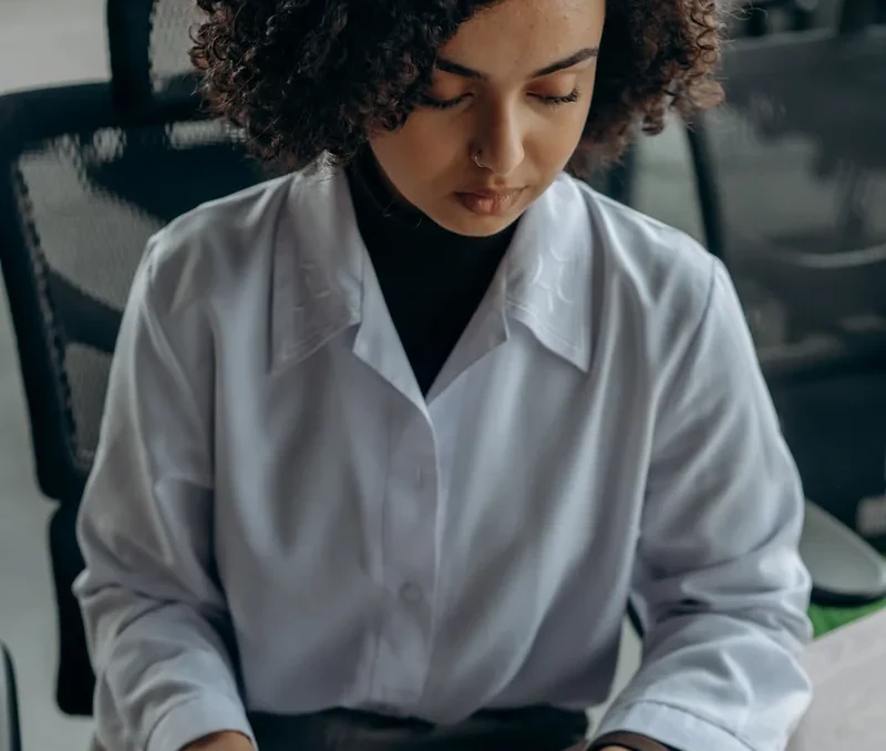 Accounting professional using a calculator at a desk