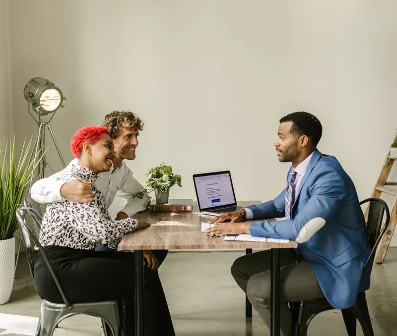 Financial advisor meeting with clients in an office