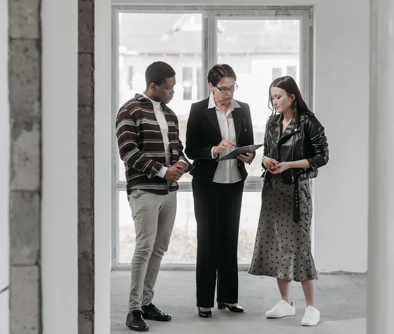 Real estate professional discussing property details with clients