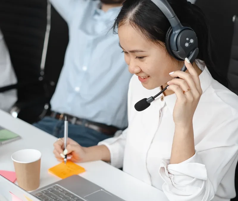 Sales professional using a headset in an office